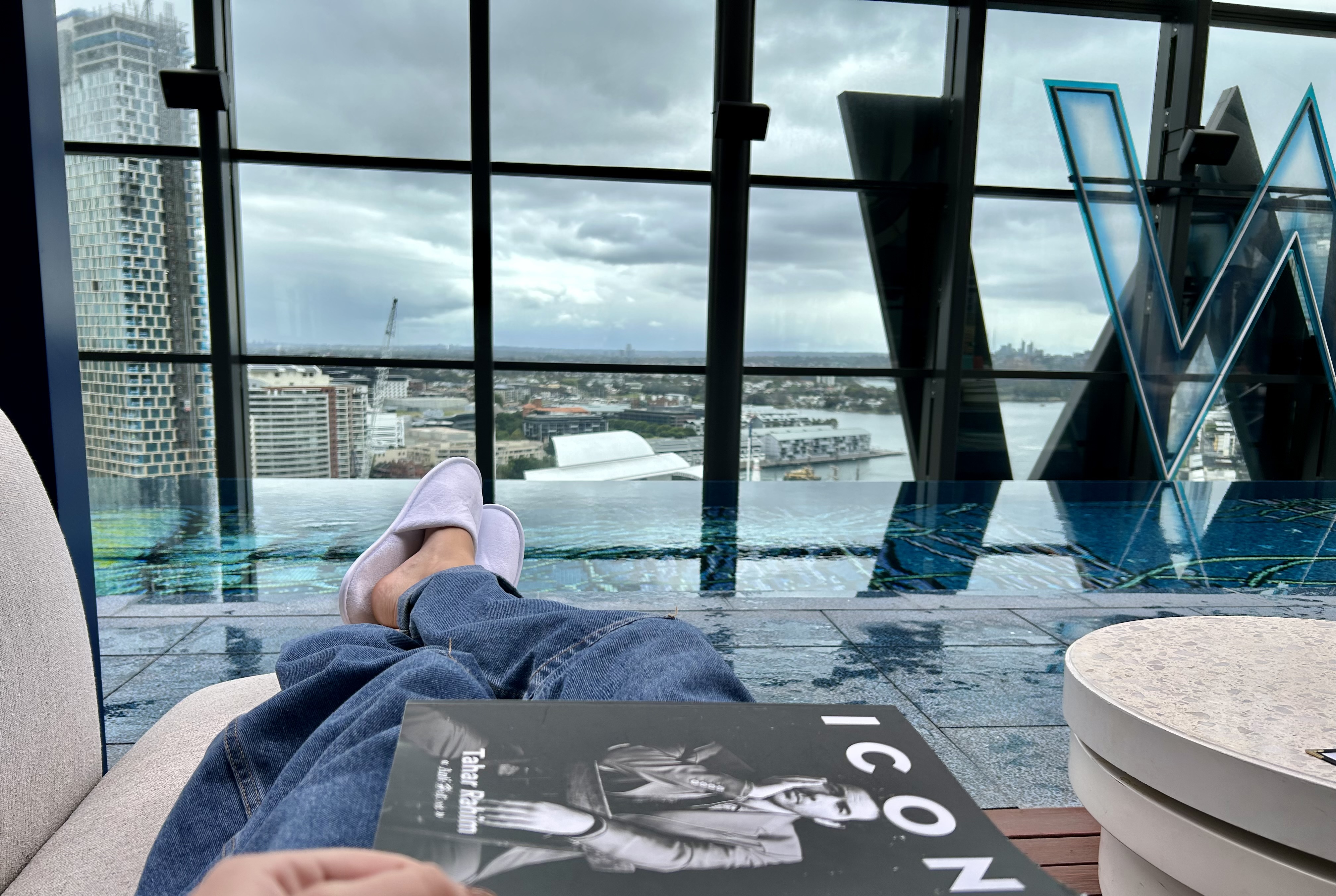 Relaxing beside an indoor pool overlooking the harbour
